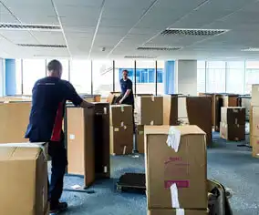 Two local movers unloading moving boxes